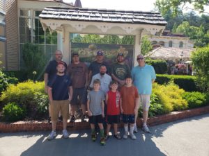 Men in front of Dollywood sign.