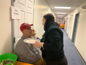 Aubrey painting Pastor Steve's face.