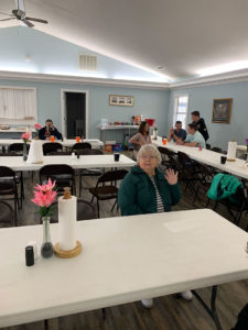 Guest (Pat Black) with church members in the background.