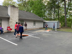 Kids playing cornhole.