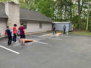 Kids playing cornhole.