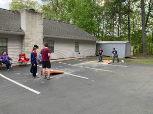 Kids playing cornhole.