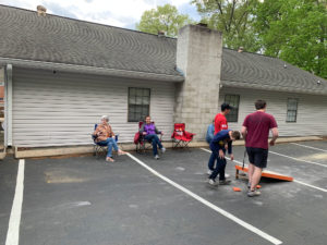 Kids playing cornhole.