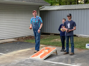 Steve, Devan, and James playing cornhole.