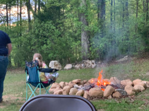 Kaylee sitting by the fire.